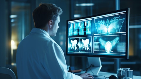 A doctor examining the results of a patient's medical scan displayed on a computer monitor.