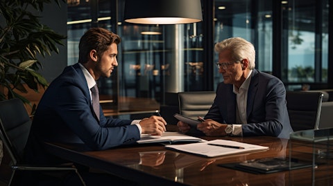 An investment banker consulting with a customer on their portfolio in a professional setting.