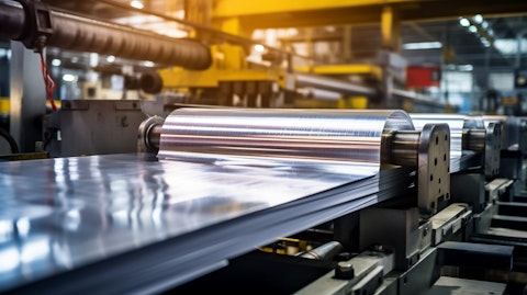 A closeup of a freshly rolled aluminum product being produced in a factory.