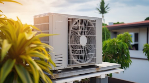 A commercial air conditioning unit mounted atop a residential roof in a suburban neighbourhood.