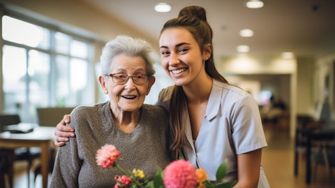 A supportive smile shared between a care facility staff member and a resident with Alzheimer's or Dementia.