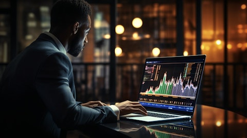A professional in a suit looking at data on a laptop, representing the store information of the company.
