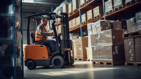 A forklift operator stacking shelves with packaged goods in a warehouse.
