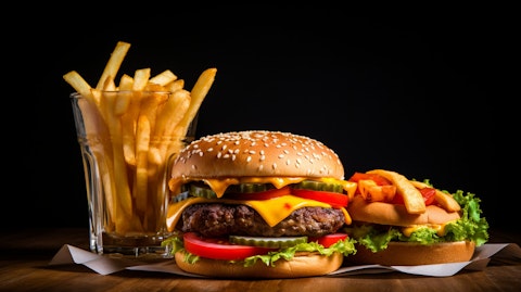 A close-up of a hamburger, french fries, and a soft drink, representing the fast food chain.