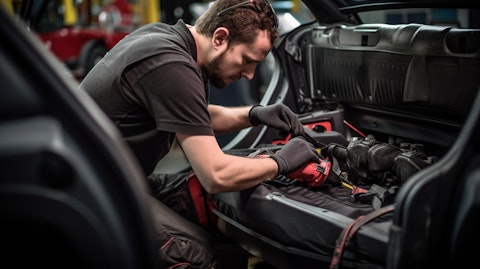 A technician installing a seat system in the interior of a car.