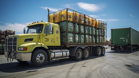 A truck filled with hazardous waste being safely unloaded at a recycling facility.