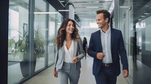 A smiling couple walking hand-in-hand out of a modern insurance office, illustrating the company's commitment to its customers.