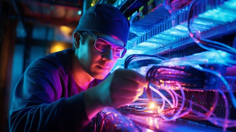 A technician wearing protective glasses installing optical fibers and cables.