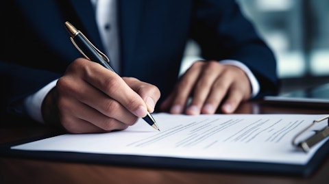 A close-up of a hand signing a property casualty insurance product contract.