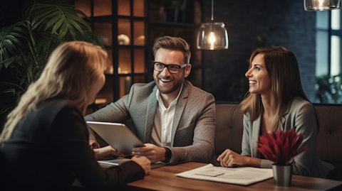 An excited real estate broker discussing with a couple interested in buying a home.