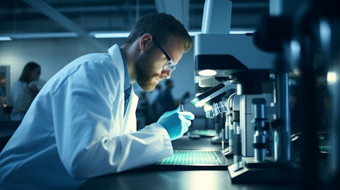 A scientist looking into a microscope in a clinical lab setting, symbolizing the cutting edge research done by the biotech company.