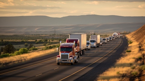 A long line of heavy-duty trucks transporting natural gas across a rural highway.