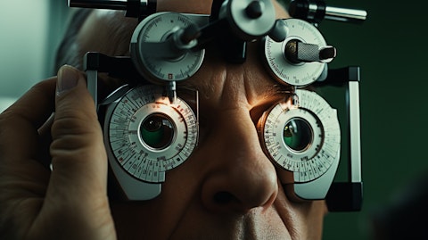 A doctor examining a patient's eyes with an ophthalmic medical device.