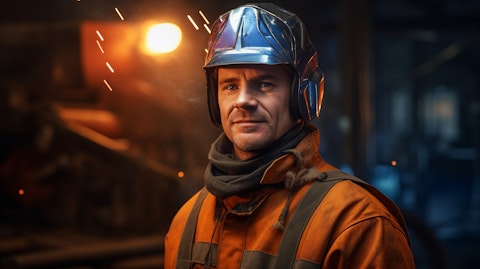 A welder wearing protective gear, wearing a satisfied expression after completing his work.