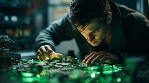 A technician looking at a circuit board of analog semiconductor products.