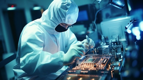 A technician in a lab coat inspecting a semiconductor processor on a microscope.