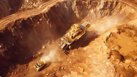 Aerial view of a gold mine with equipment mining the earth for resources.
