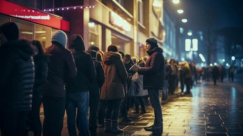 A line of eager ticket buyers outside a theatre on opening night showing the demand for live events.