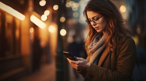 A woman using a smartphone to access a service provided by the company.