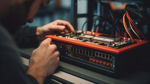 Close-up of a technician's hands adjusting a communication router.