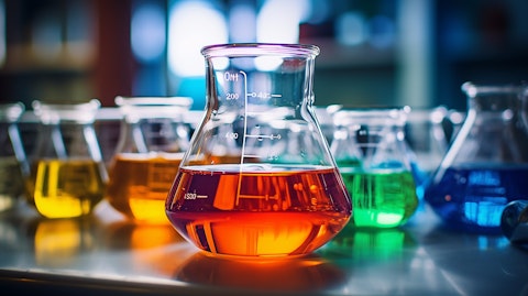 A close up of a laboratory beaker filled with colorful chemicals, signifying the company's specialty chemicals.