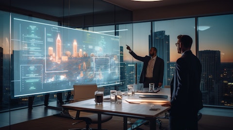 An expert IT engineer demonstrating a new software solution to hotel managers in a boardroom.