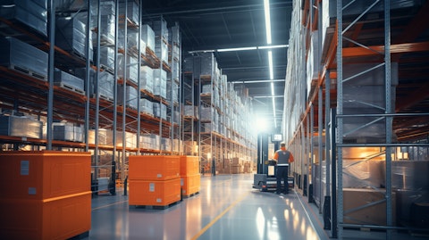 An interior of a modern temperature-controlled warehouse with industrial shelving units and workers in motion.