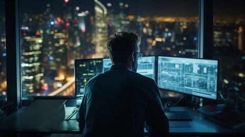 A closeup of a software engineer working in their office, overlooking a city skyline.