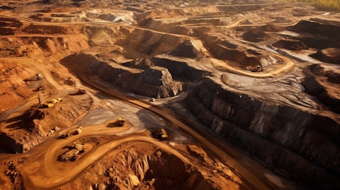 An aerial view of a large gold mine showing the extensive activity of natural resource extraction.