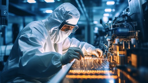 A scientist in a lab coat and goggles operating a state-of-the-art semiconductor production line.