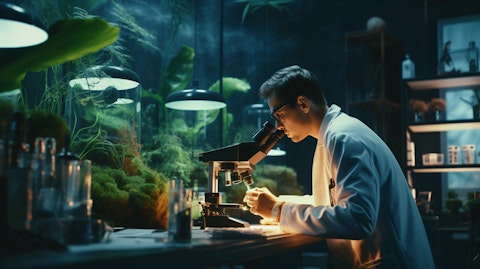 A biotechnology laboratory with a scientist working with a microscope on a volixibat drug.