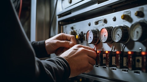 A close up of a technician’s hands manipulating a temperature control system for a thermal system.