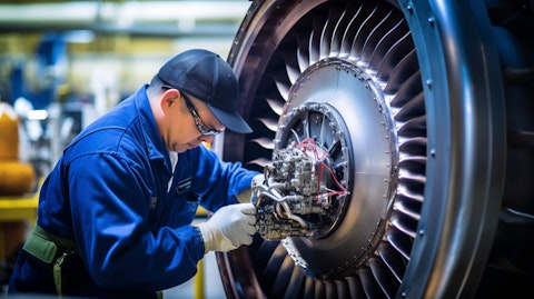 A technician inspecting a commercial jet engine in a specialized testing facility.