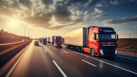 A fleet of long-haul cargo trucks on the highway transporting goods across long distances.