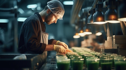 A worker in a factory pouring a plant-based product into a mould.