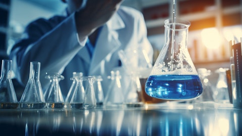 A closeup of a scientist in a lab coat, mixing two liquids for a compound to treat rare diseases.