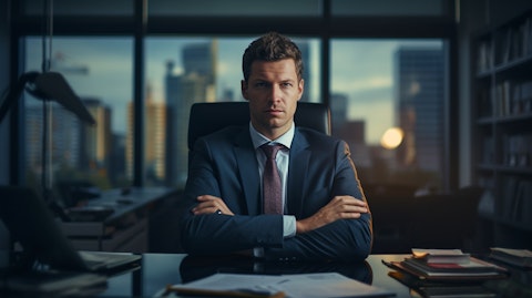 A person sitting at a desk, their arms crossed, expressing the confidence of asset management and administration.