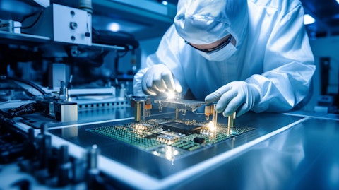 A worker assembling the inner circuitry of a semiconductor product.