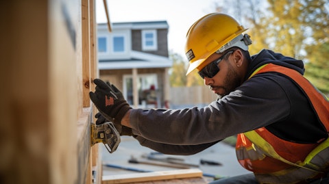 A construction worker installing a garage door in a new residential home.