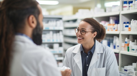 A pharmacist and a customer discussing a novel therapeutic oral health product in a pharmacy.