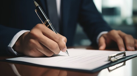 A close-up of a customer signing a mortgage document inside a bank branch.