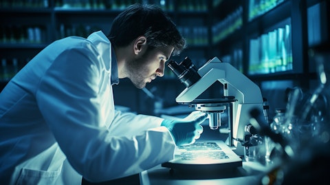 A scientist in a laboratory using advanced microscopes to analyze tumor cells.