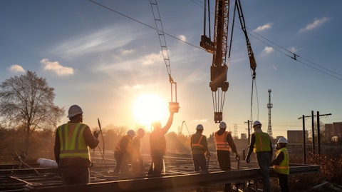 A construction crew using a crane to install a new electric substation.