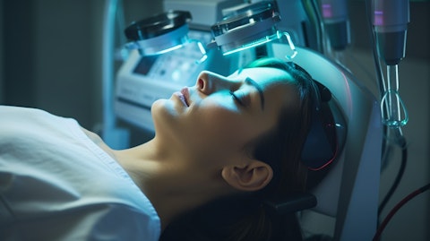 A medical technician examining a device used in laser and energy-based aesthetics systems.