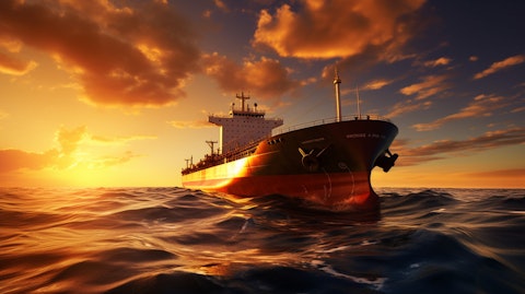 A tanker full of oil in the middle of an ocean with the sun setting in the background.