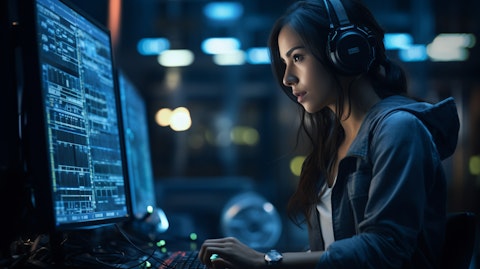 A female engineer in a datacenter, wearing a headset, monitoring digital data.
