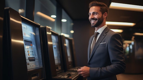 A man in a suit and tie, placing a deposit in a bank and smiling confidentally.