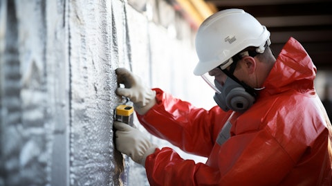 A technician meticulously inspecting a corrosion-resistant insulation panel for a fire-protection system.