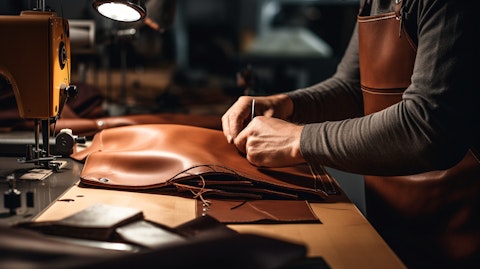 A skilled worker cutting and stitching leather for the company's high-end furnishings and fixtures.