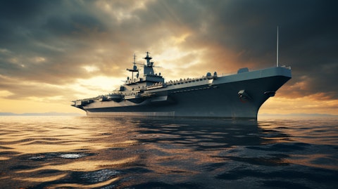 A towering military warship off the shore, its hull representing the companies commitment to the defense sector.